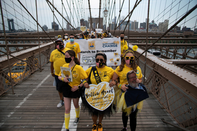 People walk across the Brooklyn Bridge together for those who were lost due to coronavirus disease (COVID-19) in New York, U.S., August 7, 2021. REUTERS/Eduardo Munoz