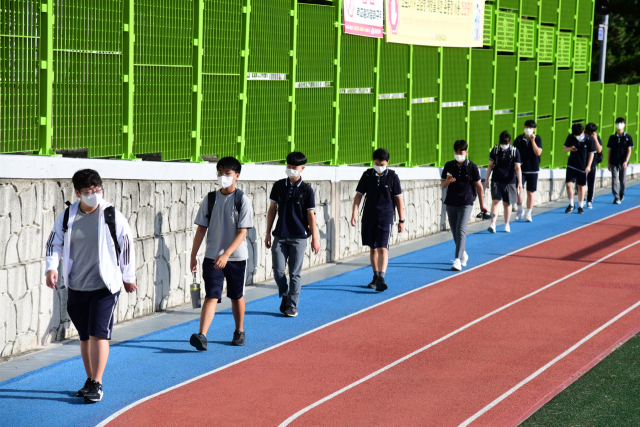 지난 2일 개학한 제주시 한라중학교 학생들이 마스크를 착용하고 일정 거리를 유지한 채 등교하고 있다. /연합뉴스