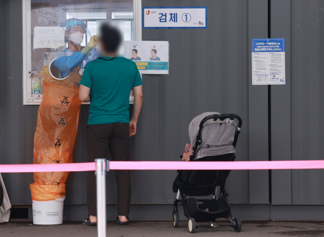 코로나189 임시 선별검사소를 찾은 시민이 검사를 받고 있다. /연합뉴스