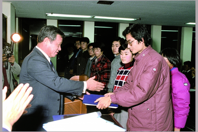 고(故) 최종현(왼쪽 첫 번째) SK그룹 선대회장이 1986년 해외 유학을 앞둔 한국고등교육재단 장학생들에게 장학증서를 전달하고 있다./사진 제공=SK