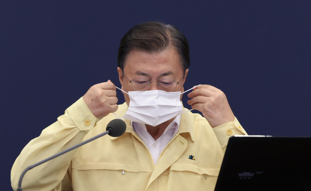 문재인 대통령이 30일 오후 청와대에서 열린 수석·보좌관회의에서 발언을 마친 뒤 마스크를 쓰고 있다. /연합뉴스