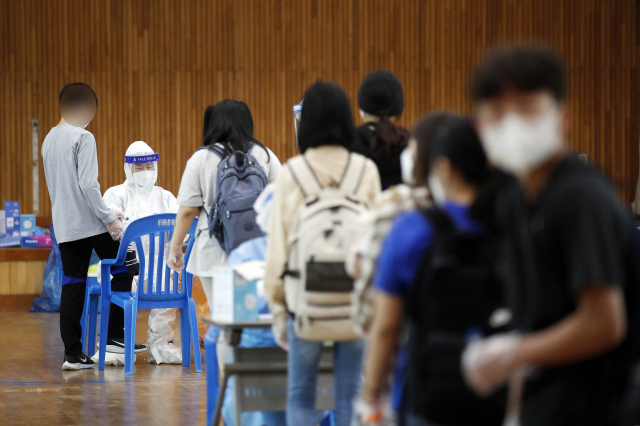 7일 광주 북구의 한 중학교에서 총 13명의 코로나19 확진자가 발생해 학생들이 전수검사를 받고 있다. /연합뉴스