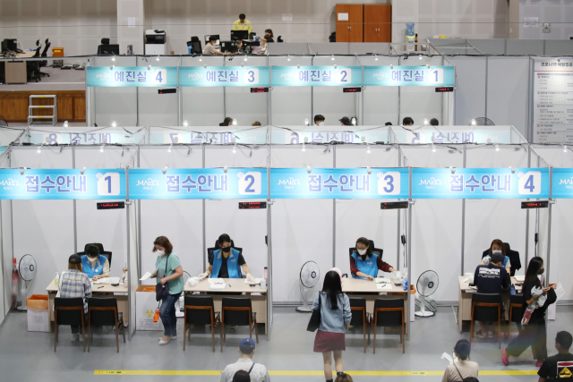 7일 오후 서울 마포구민체육센터에 마련된 코로나19 예방접종센터를 찾은 시민들이 접수하고 있다. /연합뉴스