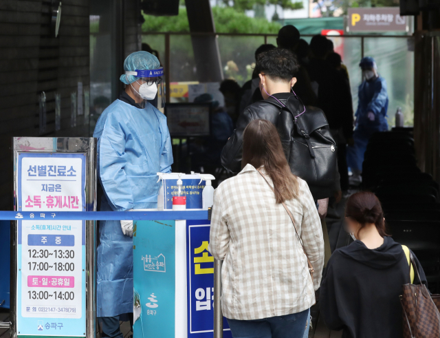 12일 서울 송파구 보건소 선별진료소에서 코로나19 검사를 기다리고 있다./연합뉴스