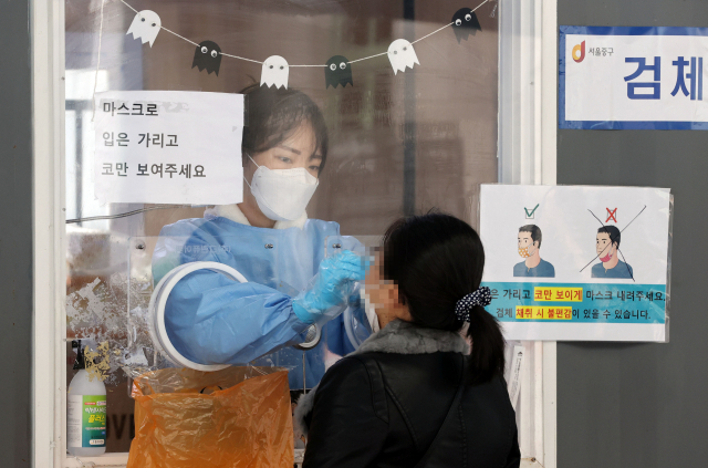 19일 코로나19 임시선별검사소에서 의료진이 검체를 채취하고 있다./연합뉴스
