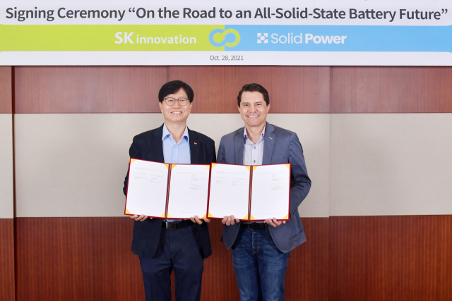 28일 대전 환경과학기술원에서 이성준(왼쪽) SK이노베이션 환경과학기술원장과 더그 캠벨 솔리드파워 CEO가 업무협약서를 들어보이고 있다.
