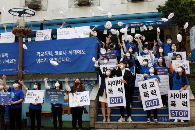푸른나무재단이 3일 서울 서초구 본부 앞에서 개최한 사이버 폭력 예방 행사에서 관계자들이 가면을 던지는 퍼포먼스를 하고 있다. /사진 제공=삼성전자