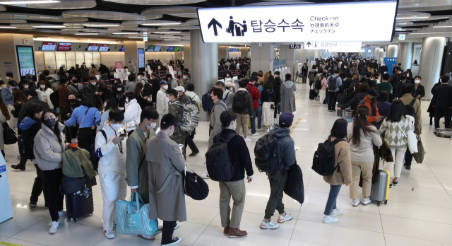 진에어 승객들이 12일 오전 김포국제공항 탑승 수속장에서 발권 및 수화물 접수를 위해 길게 줄을 서 있다. 진에어는 해외 서버 문제로 여객 서비스 시스템이 전산 장애를 일으켰다고 밝혔다./이호재 기자