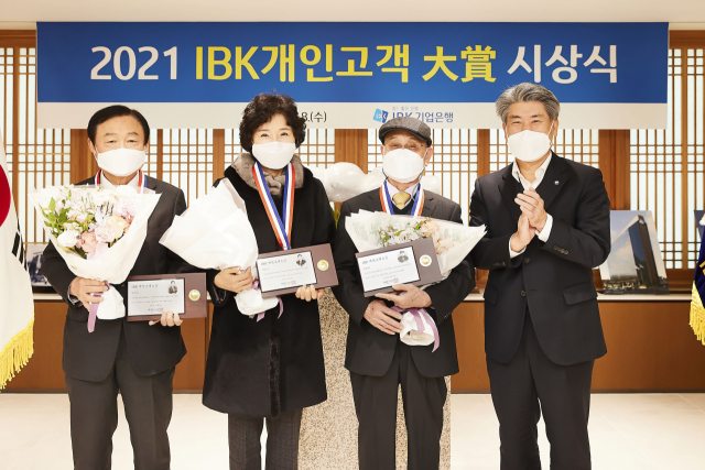 윤종원(오른쪽) IBK기업은행장이 8일 서울 중구 기업은행 본점에서 ‘2021 IBK개인고객 대상’ 시상식을 열고 수상자들과 기념촬영을 하고 있다./사진 제공=기업은행