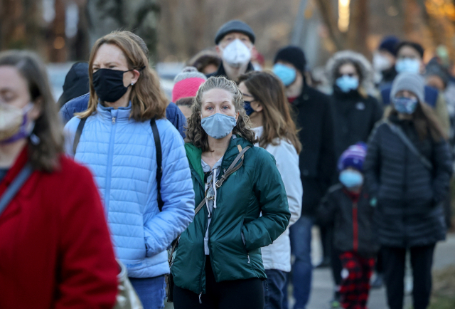 미국 시민들이 워싱턴의 한 지역 소방서에서 무료 코로나 19 테스트를 받기 위해 길게 줄을 서서 기다리고 있다./로이터 연합뉴스