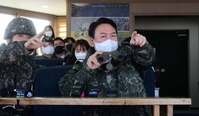 윤석열 국민의힘 대선 후보가 20일 강원 철원군 육군 3사단 백골부대 전방관측소(OP)를 찾아 손식 사단장의 설명을 들으며 전방지역을 바라보고 있다. /연합뉴스