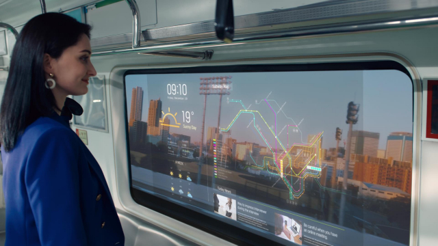LG디스플레이 모델이 ‘지하철 윈도우용 투명 OLED’를 통해 바깥 풍경을 보는 동시에 운행스케줄과 위치정보, 일기예보, 뉴스 등 생활정보를 살펴보고 있다./사진 제공=LG디스플레이
