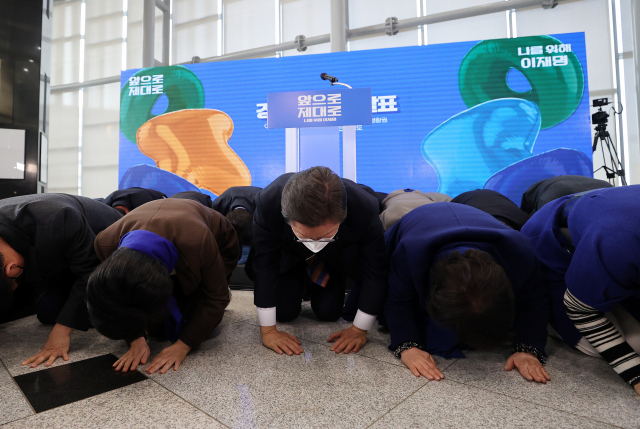 이재명 더불어민주당 대선 후보가 24일 경기도 용인시 용인포은아트홀에서 경기도 정책 공약을 발표하기에 앞서 경기도에 지역구를 둔 민주당 의원들과 함께 앞으로 더 잘하겠다는 뜻으로 큰절을 하고 있다. /권욱 기자