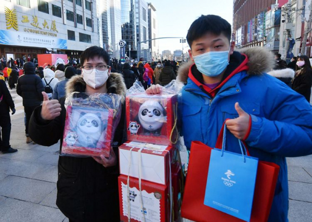 2022 베이징 동계올림픽 공식 상품 중 가장 인기가 좋은 빙둔둔 인형을 구매한 중국인들이 4일 엄지 손가락을 치켜세우고 있다. 신경보