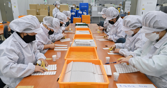 10일 경기 수원시 권선구에 위치한 래피젠 공장에서 직원들이 코로나19 자가진단키트를 생산하고 있다. 수원=오승현 기자