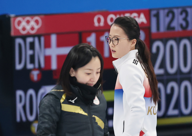 한국 스킵 김은정(오른쪽)과 일본 스킵 후지사와 사쓰키가 지난 14일 중국 베이징 국립 아쿠아틱 센터에서 열린 2022 베이징 동계올림픽 여자 컬링 리그 6차전에서 하우스를 오가며 엇갈리고 있다. /연합뉴스