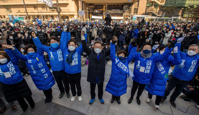 이재명 더불어민주당 대선 후보가 17일 서울 성동구 왕십리역 앞에서 열린 집중 유세에서 지역 의원들과 함께 손을 들어올리고 있다. 권욱 기자