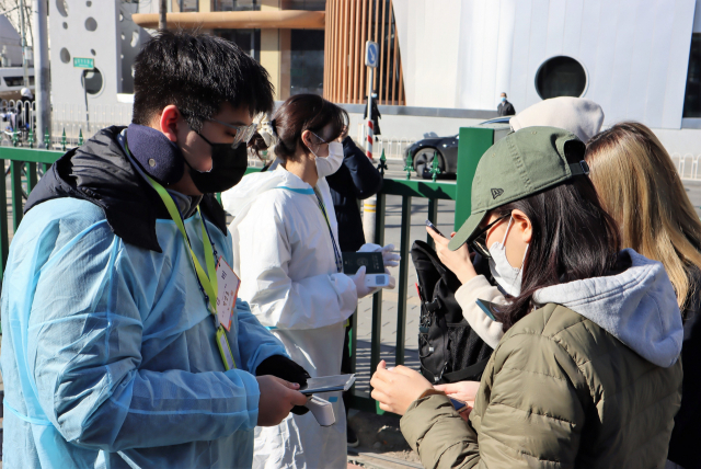 제20대 대통령 재외선거가 시작된 23일 베이징 주중한국대사관에 투표하러 온 교민이 투표소 입장 전 건강코드와 체온검사를 하고 있다. 김광수특파원