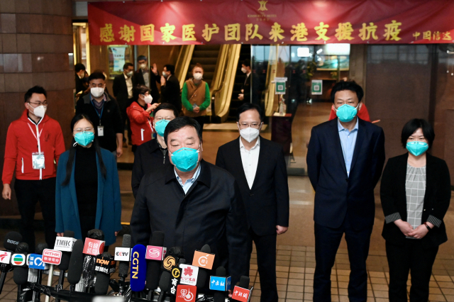량완녠(앞줄 가운데) 국가위생건강위원회 코로나19대응전담팀장을 포함한 전문가들이 28일 홍콩에 도착한 후 기자들의 질문에 답하고 있다. 로이터연합뉴스