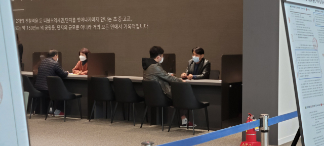 19일 서울 강동구 둔촌동 ‘올림픽파크 포레온’ 견본주택에서 조합원들이 시공사업단 관계자들에게 최근 조합 집행부와 시공단 간 갈등 상황에 대한 설명을 듣고 있다. 이덕연 기자