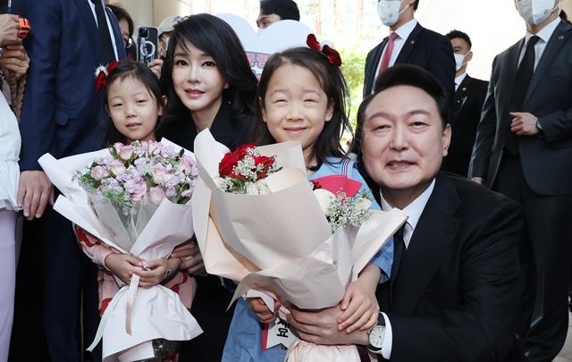 윤석열 대통령과 김건희 여사가 10일 오전 제20대 대통령 취임식에 참석하기 위해 서울 서초구 서초동 자택을 나서며 주민들로부터 꽃다발을 받고 있다. 연합뉴스