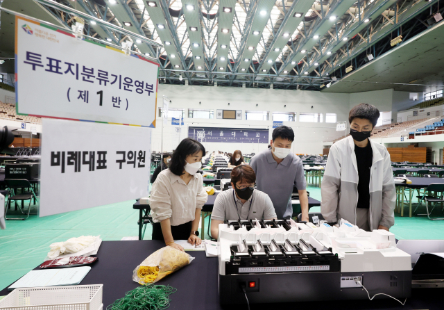 6·1 지방선거와 국회의원 보궐선거를 하루 앞둔 31일 개표소로 운영될 서울대 종합체육관에서 선관위 관계자들이 설비 점검 및 분류기 모의시험을 하고 있다. 연합뉴스