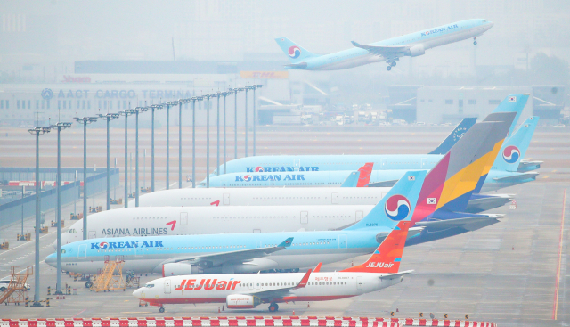 인천국제공항 주기장에 대한항공과 아시아나항공 여객기가 줄지어 서 있다. /연합뉴스