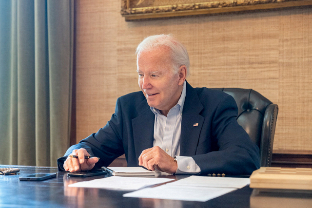 U.S. President Joe Biden, who tested positive for COVID-19 while experiencing mild symptoms, sits at his desk in the White House residence in this handout photo obtained from President Biden's Twitter account on July 21, 2022. Courtesy Twitter President Biden@POTUS/Handout via REUTERS THIS IMAGE HAS BEEN SUPPLIED BY A THIRD PARTY. THIS IMAGE WAS PROCESSED BY REUTERS TO ENHANCE QUALITY, AN UNPROCESSED VERSION HAS BEEN PROVIDED SEPARATELY.