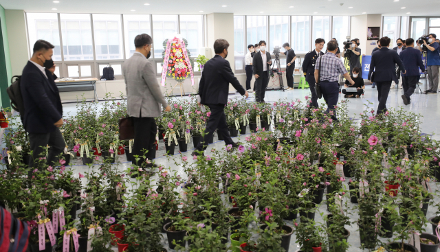 23일 오후 충남 아산 경찰인재개발원에서 열린 전국 경찰서장 회의를 마친 총경급 간부 참석자들이 회의장 밖으로 나오고 있다. 이날 회의에 참석하지 못한 총경급 간부 350여 명은 '국민의 경찰' 리본이 매인 무궁화 화분을 보냈다. / 연합뉴스