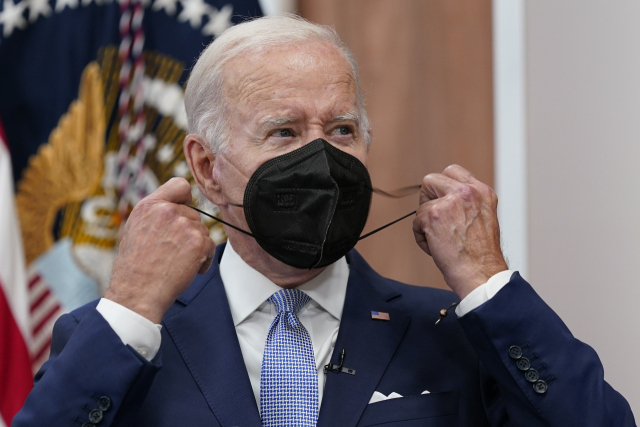 조 바이든 미국 대통령이 30일(현지 시간) 백악관에서 열린 최고경영자(CEO) 미팅에 참석한 뒤 마스크를 벗고 있다. AP연합뉴스