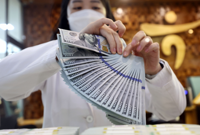서울 중구 하나은행 위변조대응센터에서 한 직원이 달러를 정리하고 있다. 연합뉴스