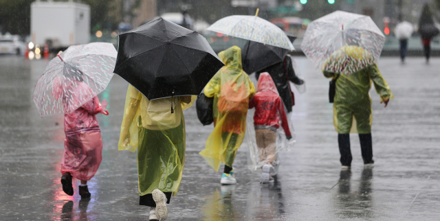 어린이들이 태풍 힌남노의 영향으로 비가 내린 5일 서울 종로구 광화문광장을 지나 하교하고 있다. 연합뉴스