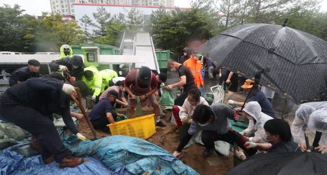 제11호 태풍 '힌남노'가 북상 중인 지난 5일 오후 경남 창원시 마산합포구 구항배수펌프장에서 시민이 모래주머니를 제작하고 있다. 연합뉴스