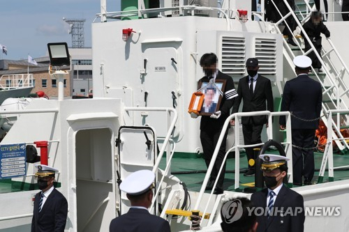 서해상에서 북한군에 피살된 고(故) 이대준 해양수산부 주무관의 추모 노제가 지난 22일 낮 전남 목포시 서해어업관리단 전용 부두에서 엄수돼 고인의 동료들이 어업지도선 무궁화 10호에 도착한 장례 행렬을 맞이하고 있다./연합뉴스