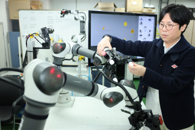 한국생산기술연구원 AI·로봇연구부문 배지훈 부문장이 로봇 그리퍼를 살펴보고 있다. 사진제공=한국생산기술연구원