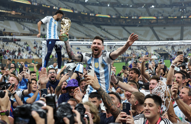 아르헨티나 공격수 리오넬 메시가 19일(한국 시간) 2022 카타르 월드컵 결승전을 승리로 이끈 뒤 트로피를 들고 환호하고 있다. TASS연합뉴스