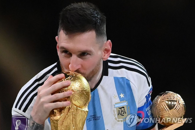 지난 19일 리오넬 메시 아르헨티나 축구대표팀 선수가 2022 카타르 월드컵 우승을 확정지은 뒤 월드컵 트로피에 입을 맞추고 있습니다. 사진=연합뉴스