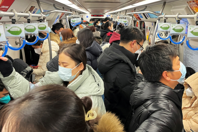 코로나19 감염자가 급증하고 있는 중국 베이징의 지하철에서 시민들이 출근하고 있다. 로이터연합뉴스