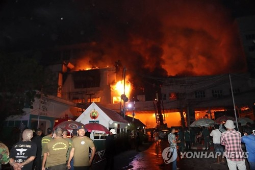 캄보디아 북서부 포이펫 그랜드 다이아몬드 시티 호텔-카지노에서 소방대원들이 전날 밤 발생한 화재를 진압하며 구조작업을 펼치고 있다. 경찰은 이날 불로 최소 10명이 사망하고 30명이 다쳤다고 밝혔다./연합뉴스