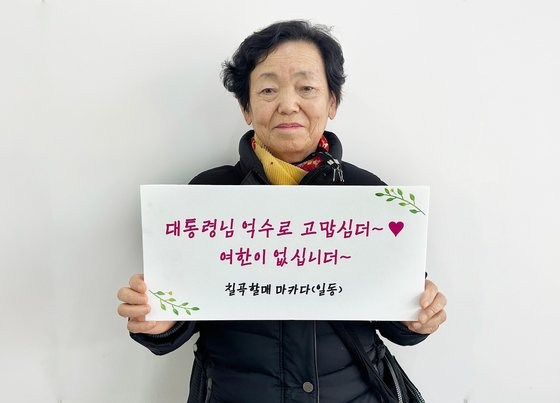 권안자 할머니가 ‘대통령님 억수로 고맙심더~ 여한이 없습니더’라고 쓰인 손팻말을 들고 기념촬영을 하고 있다. 사진=경북 칠곡군