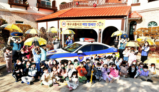 현대자동차 노사는 11일 울산북부경찰서와 초록우산 어린재단과 함께 북구 매곡동 꿈동산 유치원에서 '스쿨존 교통안전 교육'을 실시하고, 아이들과 함께 경찰차 앞에서 기념촬영을 하고 있다. 사진제공=현대자동차