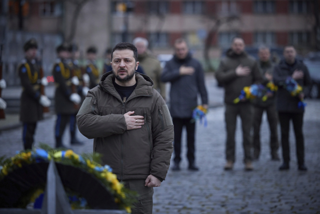 볼로디미르 젤렌스키 우크라이나 대통령이 11일(현지시간) 서부 르비우에 있는 전사자 추모비에서 참배하고 있다. 추모비는 우크라이나와 러시아간 전쟁에서 사망한 이들을 기리기 위한 것이다. AP연합뉴스