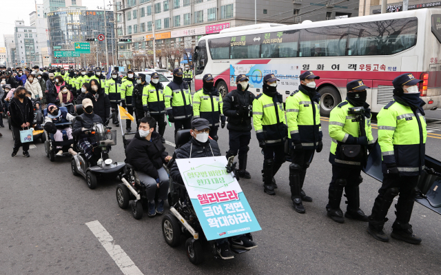 전국장애인차별철폐연대(전장연) 회원들이 19일 오후 서울 서초구 남부터미널 인근에서 시외버스 이동권 보장을 주장하며 행진하고 있다. 연합뉴스