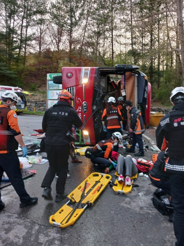 119구급대원들이 충주 수안보온천 버스 전복 사고 현장에서 부상자들을 구조하고 있다. 사진 제공=소방청