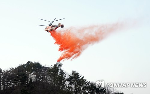 지난해 3월 경북 울진군 산불 현장에서 소방헬기가 진화에 나서고 있다. 울진=연합뉴스