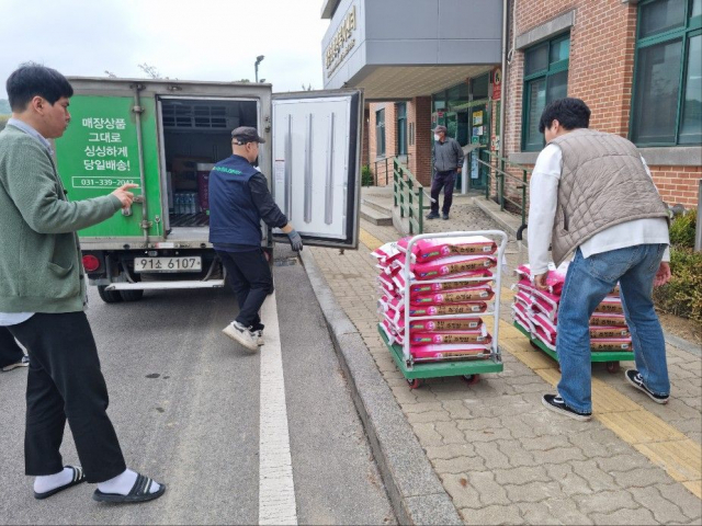 용인아산내과가 기증한 백미를 처인구 직원들이 옮기고 있다. 사진 = 처인구 제공