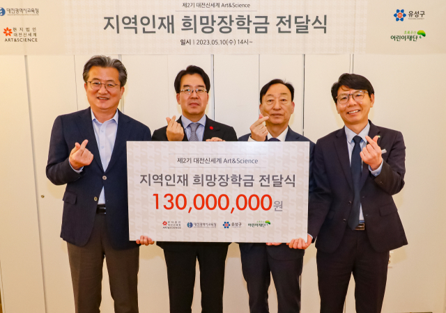 윤석희(왼쪽에서 두번째) 대전신세계 대표이사가 설동호(″세번째) 대전시교육감에게 장학금을 전달하고 있다. 사진제공=대전신세계