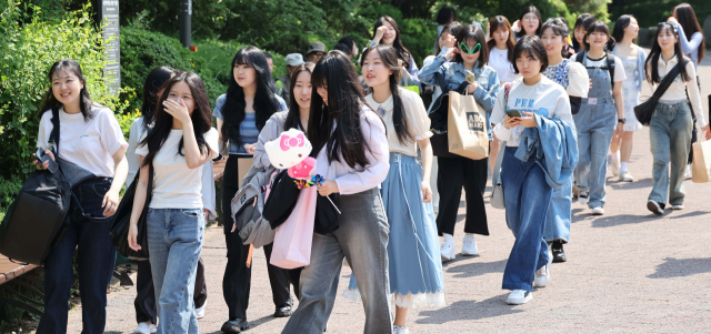 정부가 코로나19 방역 조치를 대부분 해제하며 사실상 엔데믹을 선언한 11일 서울 광진구 어린이대공원에서 고등학생들이 마스크를 벗고 밝게 웃고 있다. 권욱 기자