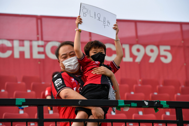 김세영(왼쪽) 바스템 대표가 부천FC를 응원하는 어린이 팬을 번쩍 들어 올리고 있다. 사진 제공=부천FC1995