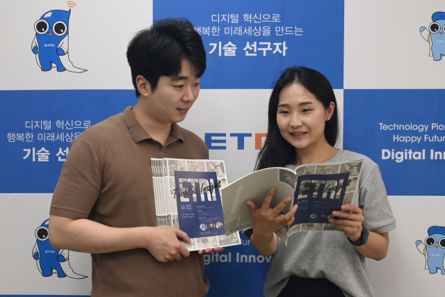 ETRI 직원들이 ETRI가 발간한 기술사업화 전문 정책지, '테크비즈 인사이트' 2호를 살펴보고 있다. 사진제공=ETRI